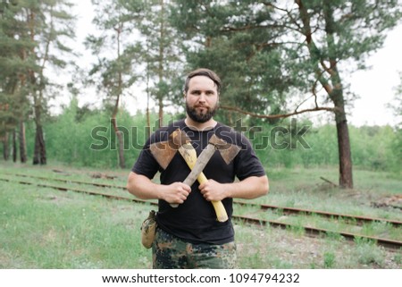 Similar – Image, Stock Photo bearded man huntsman with two axes stands near a rusty train