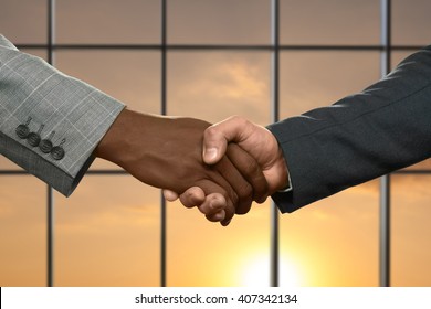 Adult businessmen shaking hands. Handshake on sunny sky background. Partnership begins from simple things. Honesty or deception. - Shutterstock ID 407342134