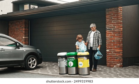 Adult Caucasian father teaching his little son sorting rubbish for recycling. People throwing bags with trash in garbage bins. Family saving environment. Concept of ecology. Organic recycling. - Powered by Shutterstock