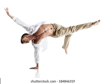 Adult Caucasian Male Dancer Wearing A White Shirt And Beige Pants. Image Is Isolated On A White Background.