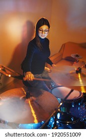 Adult Caucasian Woman Drummer Playing In Dark Room At Home Or Studio - Female Practice Rhythm On Drum Set Music Playing