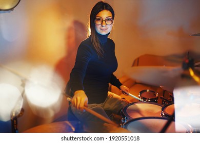 Adult Caucasian Woman Drummer Playing In Dark Room At Home Or Studio - Female Practice Rhythm On Drum Set Music Playing