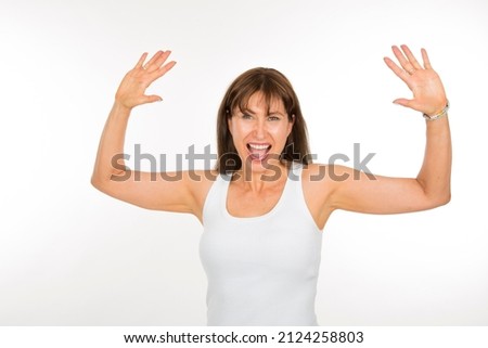 adult Caucasian woman expressing joy and elation looking at camera on white background