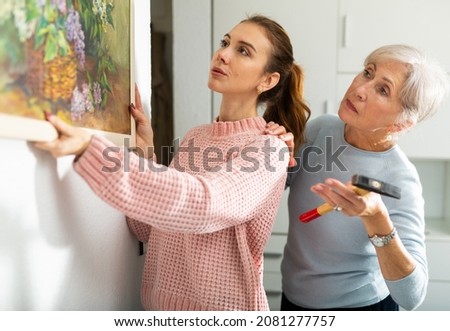 Similar – Caregiver looking through the window with elderly patient in wheelchair