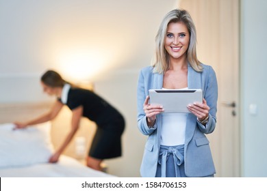 Adult Chambermaid And Hotel Manager Cleaning The Room