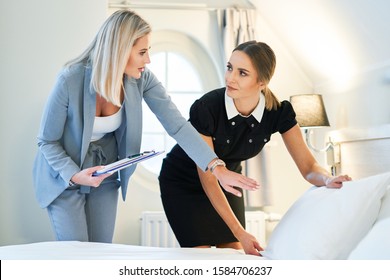 Adult Chambermaid And Hotel Manager Cleaning The Room