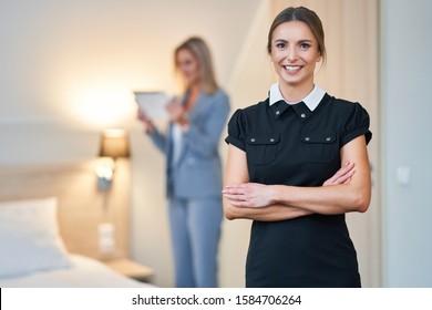 Adult Chambermaid And Hotel Manager Cleaning The Room