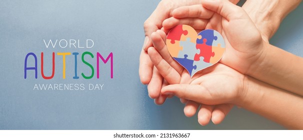 Adult and chiild hands holding jigsaw puzzle heart shape, Autism awareness, Autism spectrum family support concept, World Autism Awareness Day - Powered by Shutterstock