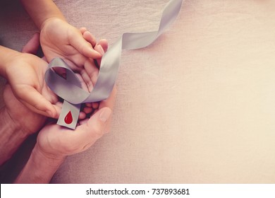 Adult And Child Hands Holding Grey Ribbon, World Diabetes Day