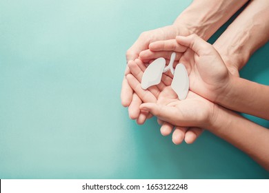 Adult and child hands holding lung, world tuberculosis day, world no tobacco day, lung cancer,  Pulmonary hypertension, Pneumonia, copd, eco air pollution,organ donation, respiratory and chest concept