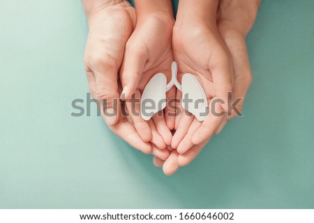 Adult and child hands holding lung, world tuberculosis day, world no tobacco day, COPD, Lung cancer, Pulmonary hypertension, eco air pollution,organ donation, healing concept