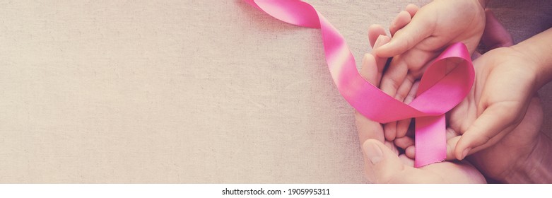 Adult and child hands holding pink ribbons, Breast cancer awareness,  October Pink , world cancer day - Shutterstock ID 1905995311