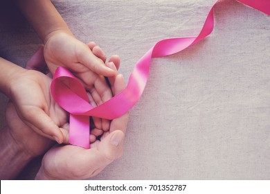 Adult And Child Hands Holding Pink Ribbons, Breast Cancer Awareness, Abdominal Cancer Awareness And October Pink Day Background, World Cancer Day