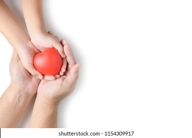 Adult And Child Hands Holding Red Heart Isolated On White Background, Health Care, Love And Family Insurance Concept, World Heart Day