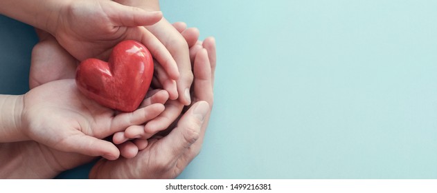 Adult And Child Hands Holding Red Heart On Aqua Background, Heart Health, Donation, CSR, Hope,wellbeing, World Heart Day, World Health Day, Family Day, Fair Trade, Foster Home Concept, Organ Donor Day