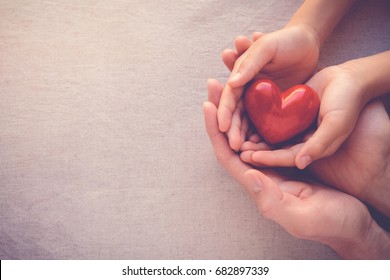 Adult And Child Hands Holding Red Heart,health Care, Donate And Family Insurance Concept,world Heart Day, World Health Day,CSR Responsibility, Adoption Foster Family, Hope, Gratitude, Kind,  Concept