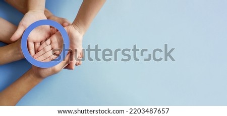 Adult and child holding circle paper cutout, world diabetes day concept