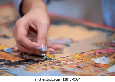 Adult And Child - Parent And Child Relaxing By Solving A Jigsaw Puzzle. 