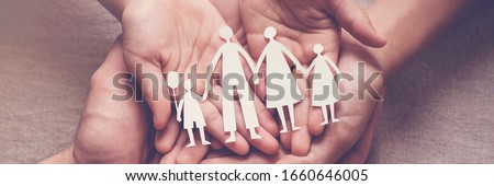 Adult and children hands holding paper family cutout, family home, adoption, foster care, homeless support, family mental health, autism support, domestic violence, social distancing concept