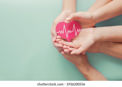 Adult And Children Hands Holding Red Heart With Cardiogram, Health Care, Organ Donation, Family Life Insurance, World Heart Day, World Health Day, Praying Concept