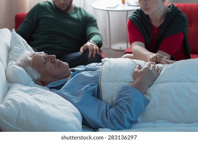 Adult Children Saying Goodbye With Aged Dying Father In Hospital