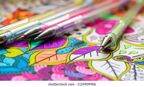 Adult Coloring Book, New Stress Relieving Trend. Art Therapy, Mental Health, Creativity And Mindfulness Concept. Adult Coloring Page With Pastel Colored Gel Pen Close Up.