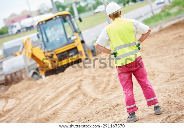 adult construction site manager worker at earthmoving roadwork