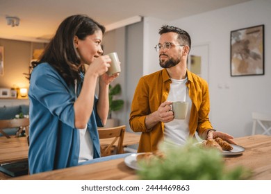 Adult couple have breakfast and cup of coffee at home morning routine - Powered by Shutterstock