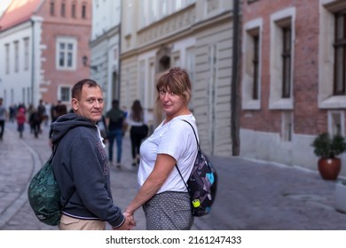 Adult Couple In Love Man And Woman 50 Years Old Holding Hands Walking Around The City