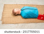  Adult CPR mannequin placed on the floor, designed for resuscitation training.Enables practice in airway opening, mouth-to-mouth breathing,and performing chest compressions for life-saving skills.

