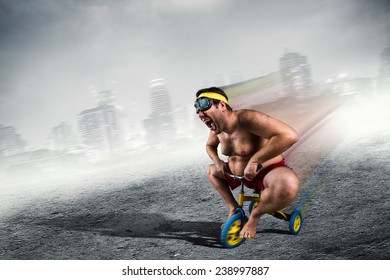 Adult Crazy Man Cycling On Child's Bicycle