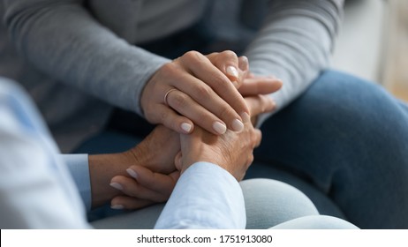 Adult daughter comforting old mom strokes holds her hand close up view. Strong connection confidential conversation, empathy and mercy, support in hard life period, be near sharing heart pain concept - Shutterstock ID 1751913080