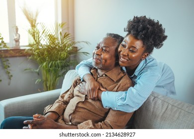 Adult daughter visits senior father in assisted living home. Portrait of a daughter holding her elderly father, sitting on a bed by a window in her father's room.  - Shutterstock ID 2134628927