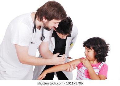 Adult Doctor Giving Injection To Young Female Patient While Student Is Watching