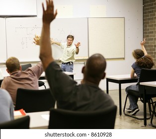 Adult Education Class Raising Hands To Ask Questions.