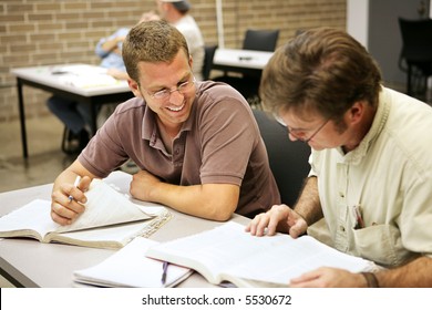 Adult Education Students Studying Together In Class.