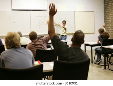 Adult Education Teacher In Front Of His Class.