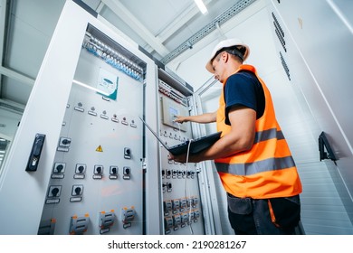 Adult electrician builder engineer testing and screwing equipment in fuse box and repairing of modern electricity power station. Automatic control cabinet - Powered by Shutterstock