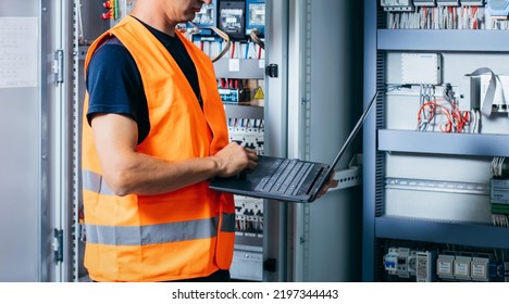 Adult electrician builder engineer testing and screwing equipment in fuse box and repairing of modern electricity power station. Automatic control cabinet - Powered by Shutterstock