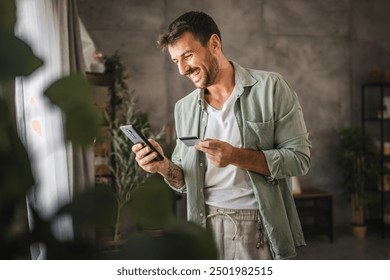 adult excited man have online shopping on cellphone with credit card