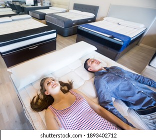 Adult family choosing mattresses in the store
