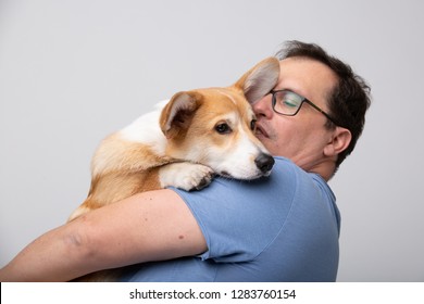 Adult Fat Man Hold Havy Corgi Dog Puppy