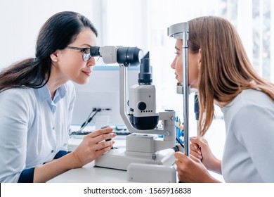 Adult Female Doctor Ophthalmologist Checking Eye Vision Of Young Girl In Modern Clinic