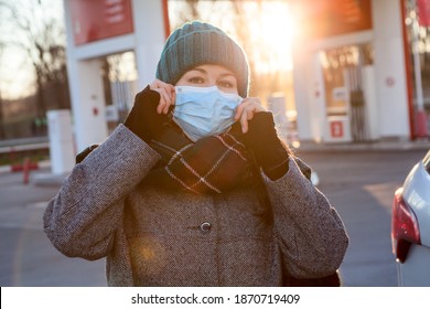 Adult Female Driver Wearing Face Mask When Going To Refuel Her Car On Petrol Station