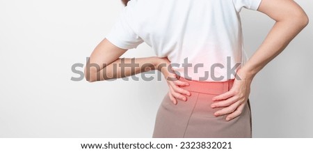 adult female with muscle pain on gray background. Elderly woman having back body ache due to Piriformis Syndrome, Low Back Pain and Spinal Compression. Office syndrome and medical concept