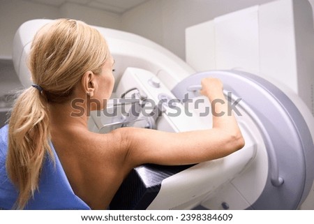 Adult female patient receiving 3D mammography in clinic