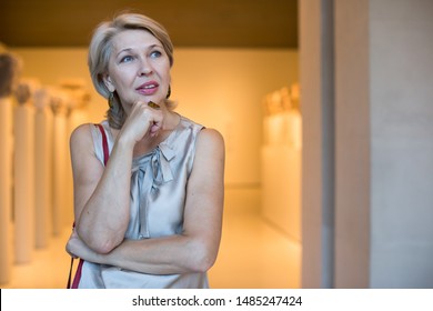 Adult female standing near the artwork in the museum indoors - Shutterstock ID 1485247424
