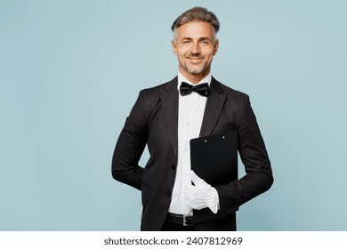 Adult fun barista male waiter butler man wear shirt black suit bow tie elegant uniform hold clipboard with menu look camera work at cafe isolated on plain blue background. Restaurant employee concept - Powered by Shutterstock