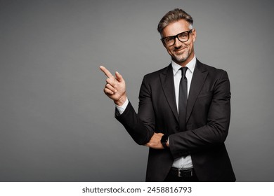 Adult fun successful employee business man corporate lawyer wear classic formal black suit shirt tie work in office point index finger aside on area isolated on plain grey background studio portrait - Powered by Shutterstock