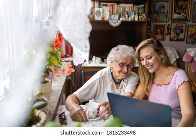 Adult granddaughter teaching her elderly grandmother to use laptop
 - Powered by Shutterstock